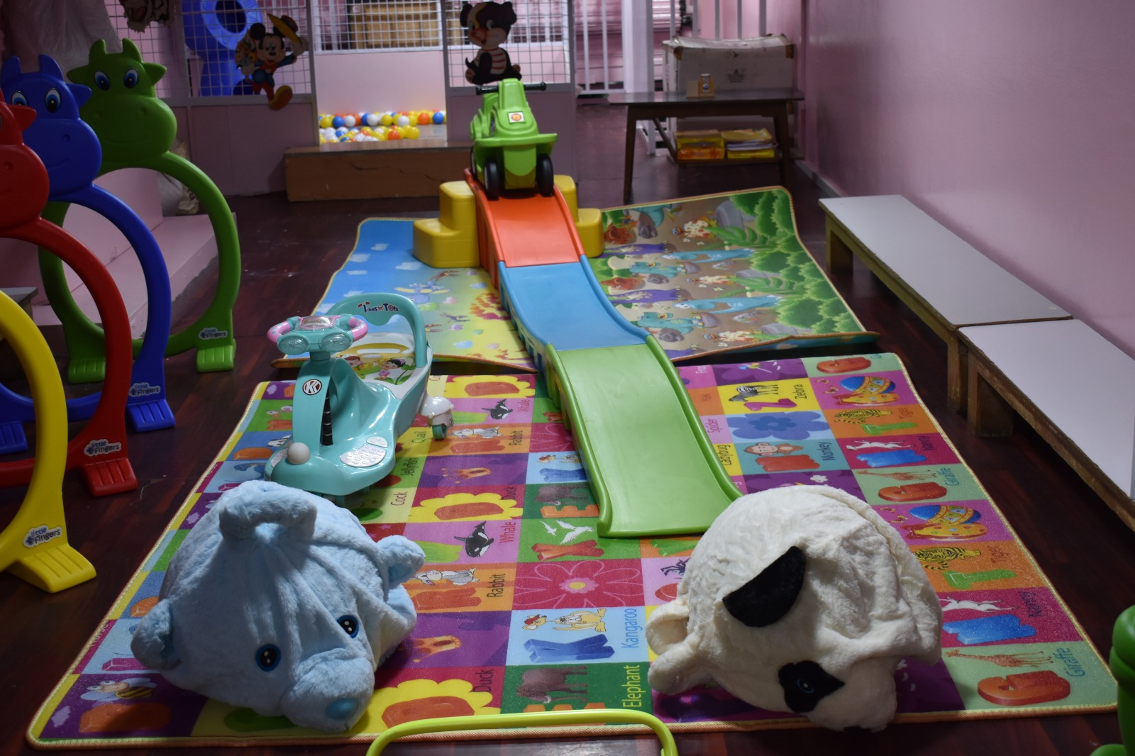 Indoor play area with slides, ride-ons and soft toys at Hanus Play Home