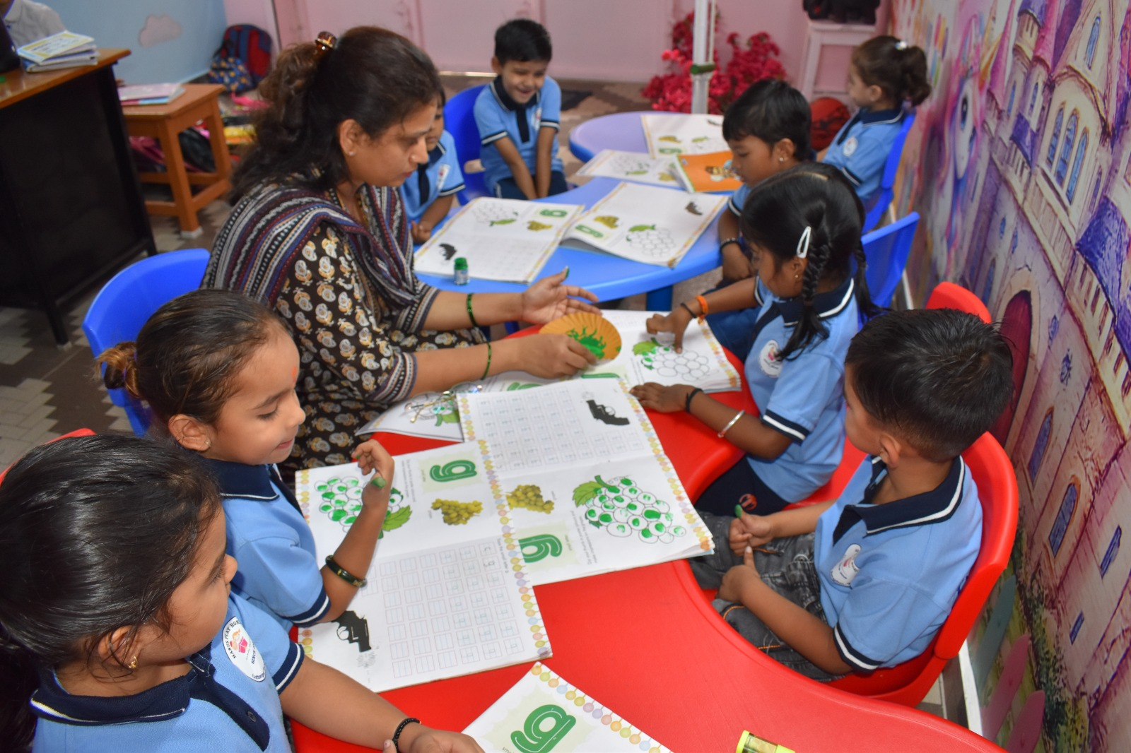 Kids engaged in a tracing and colouring activity