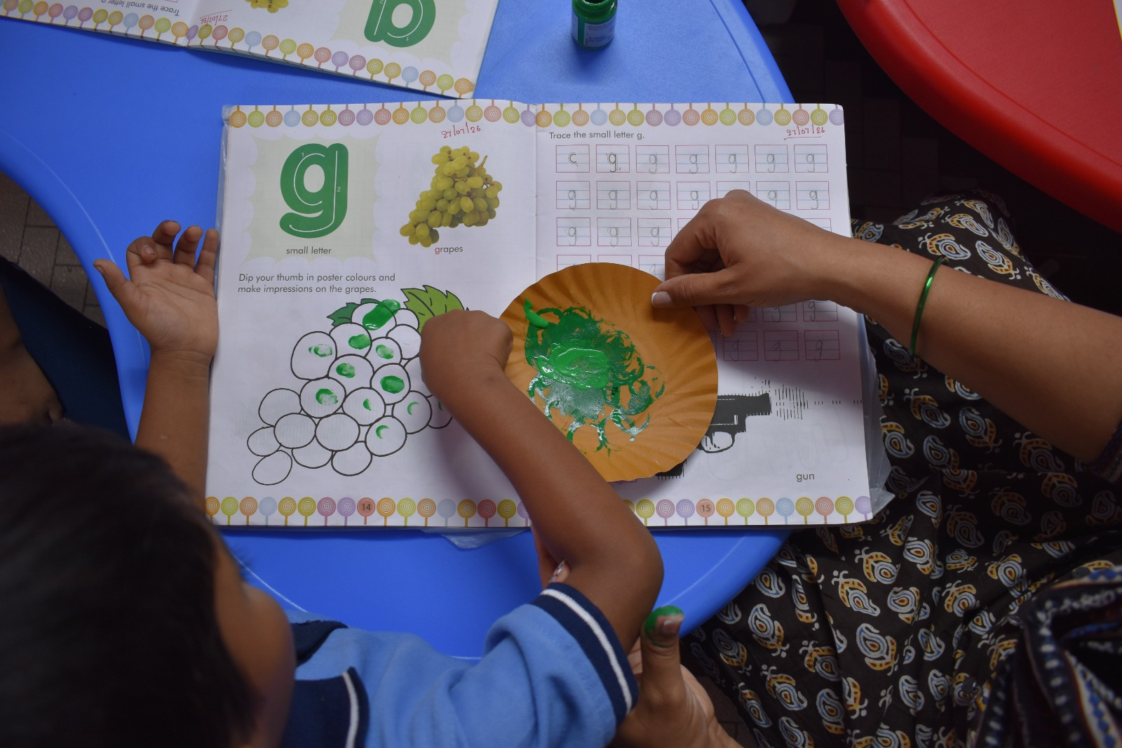 Thumb-printing art activity with the letter ‘g’